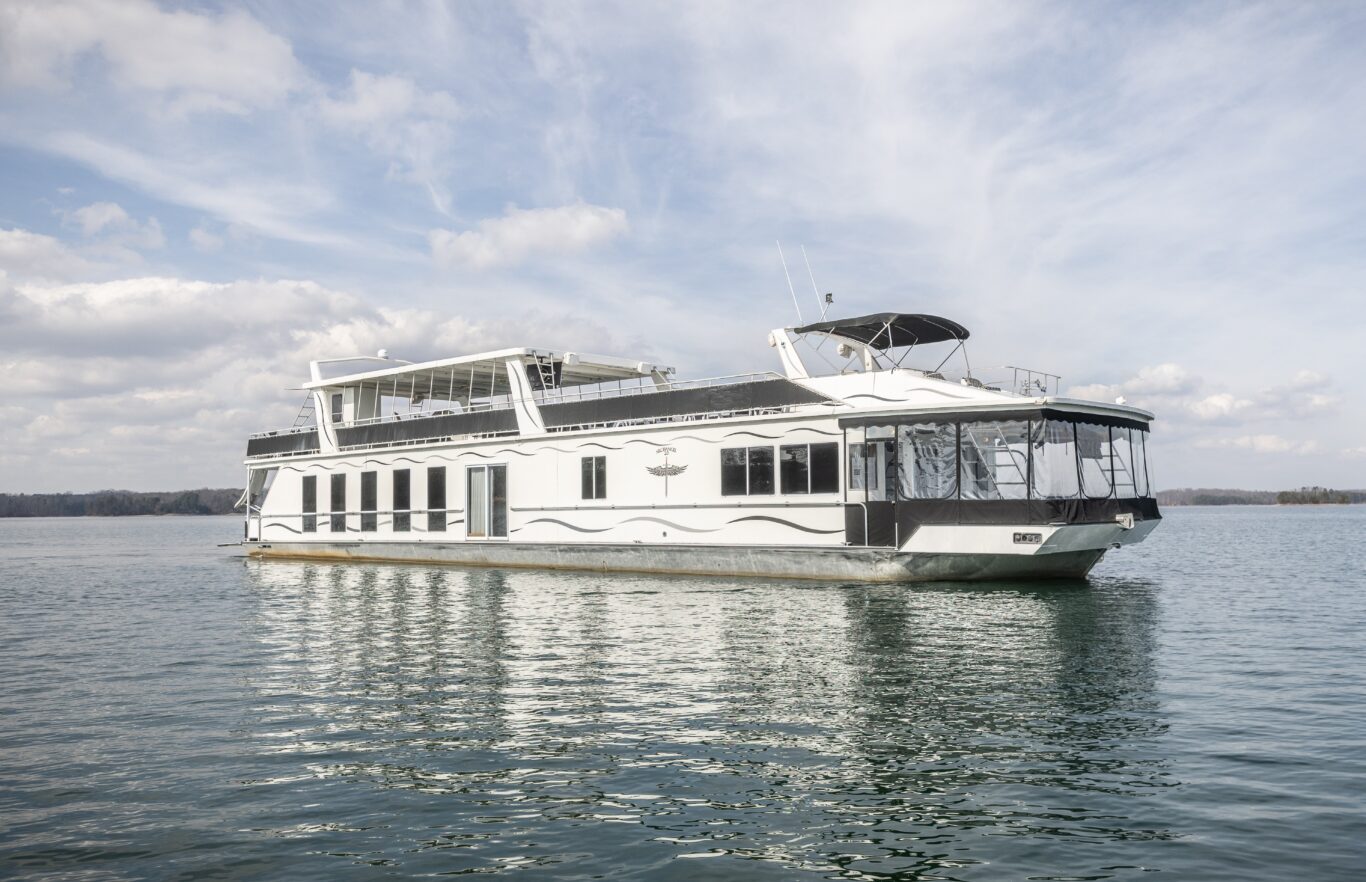 Full view of the Fantasy Luxury Houseboat cruising on Lake Lanier near Lanier Islands