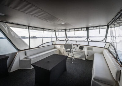 Captain steering station on the upper deck of The Stardust luxury houseboat overlooking Lake Lanier
