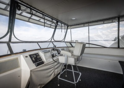 Captain helm station on the top deck of The Stardust luxury houseboat steering across Lake Lanier