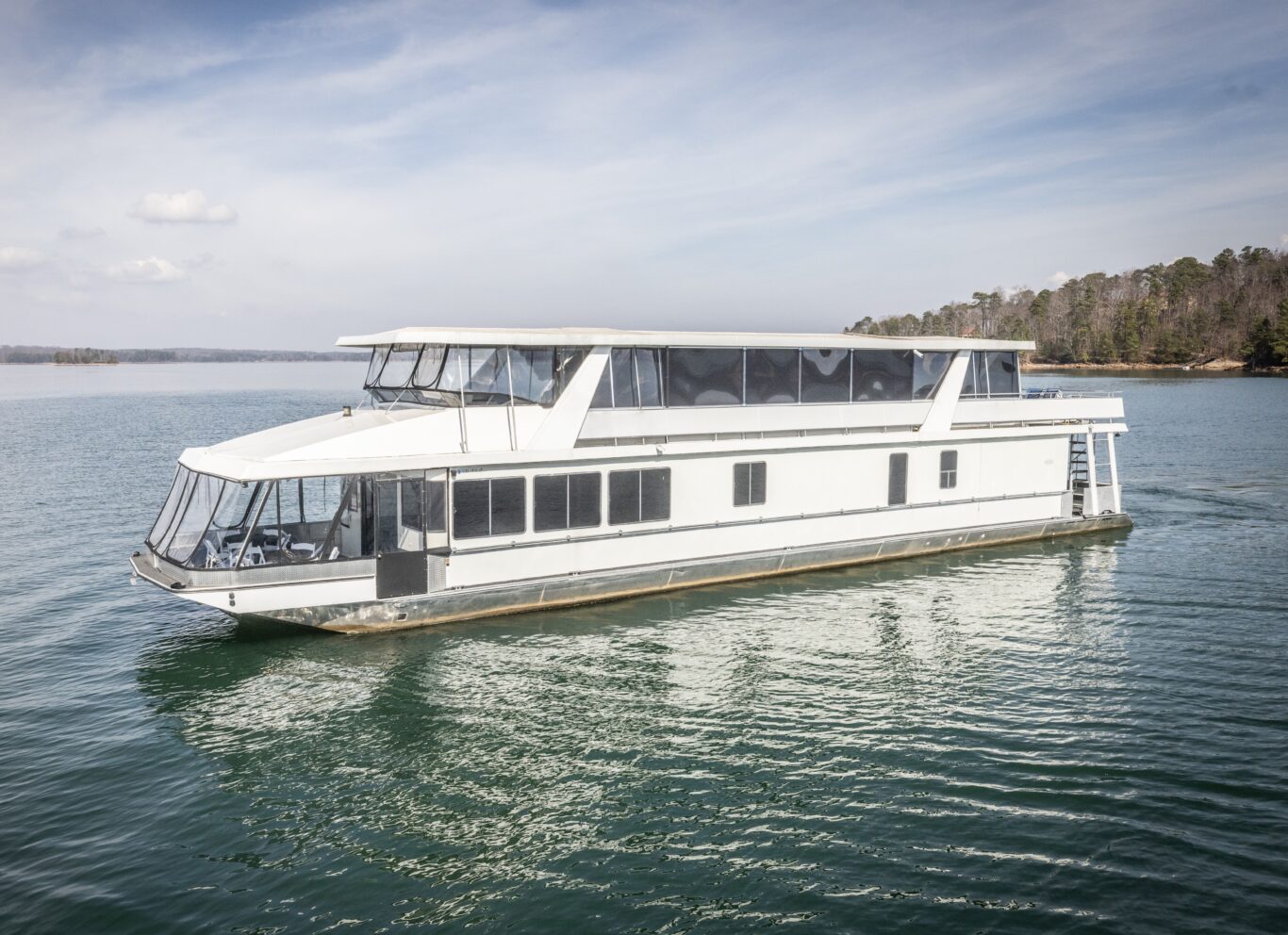 Full view of The Stardust luxury houseboat cruising on Lake Lanier near Lanier Islands