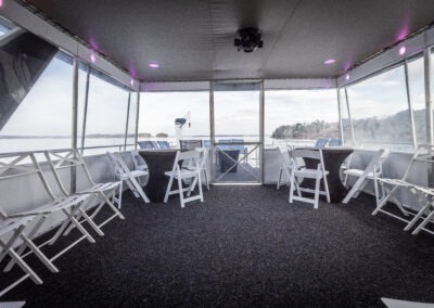 LED lit enclosed back deck lounge on The Stardust luxury houseboat during a Lake Lanier cruise
