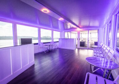 Top mid deck entertainment area with DJ booth and bar on The Stardust luxury houseboat near Lanier Islands